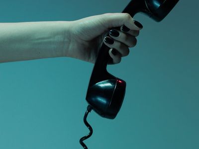 Close-up of a hand gripping a simple piece of equipment.